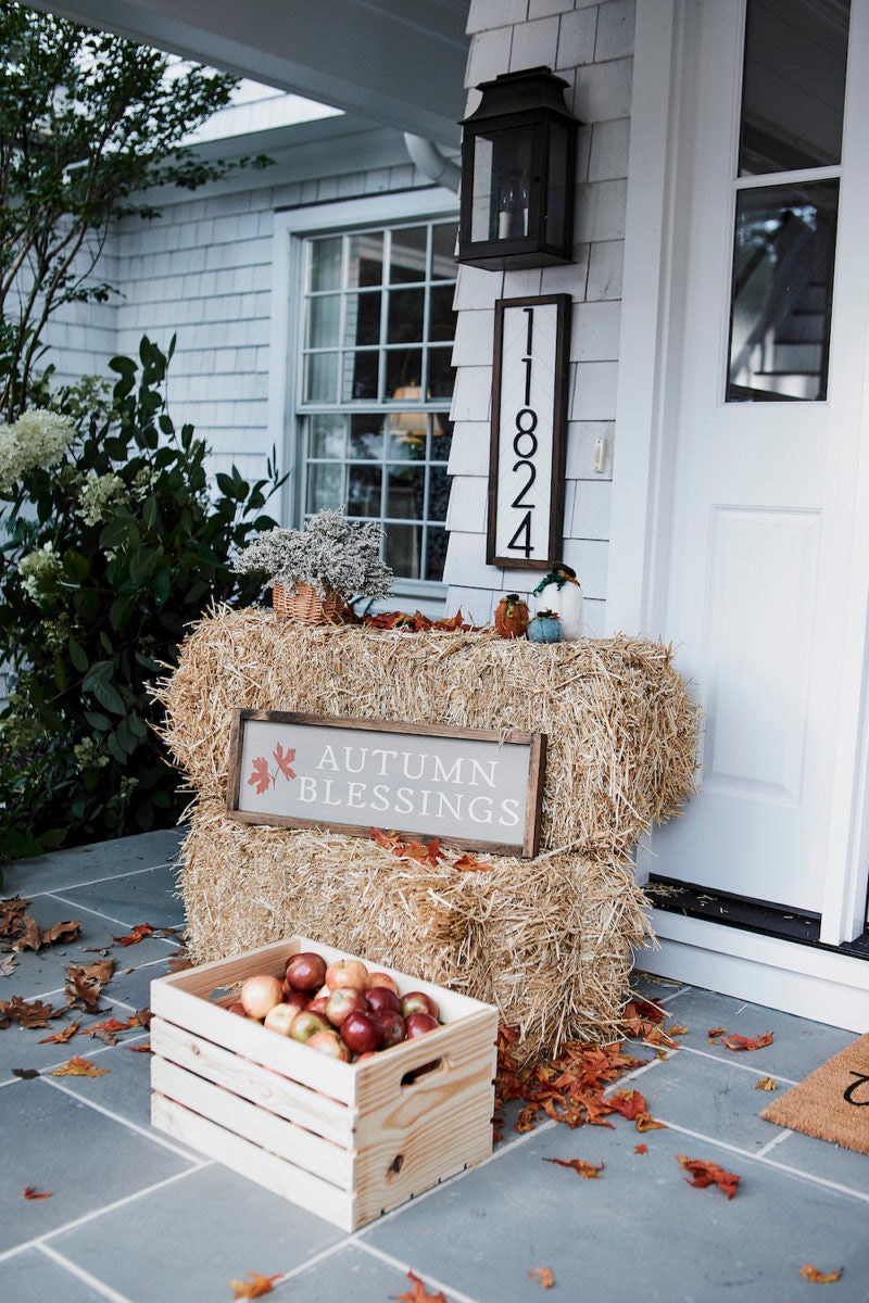 A rustic front porch styled with fall porch picks from Etsy.