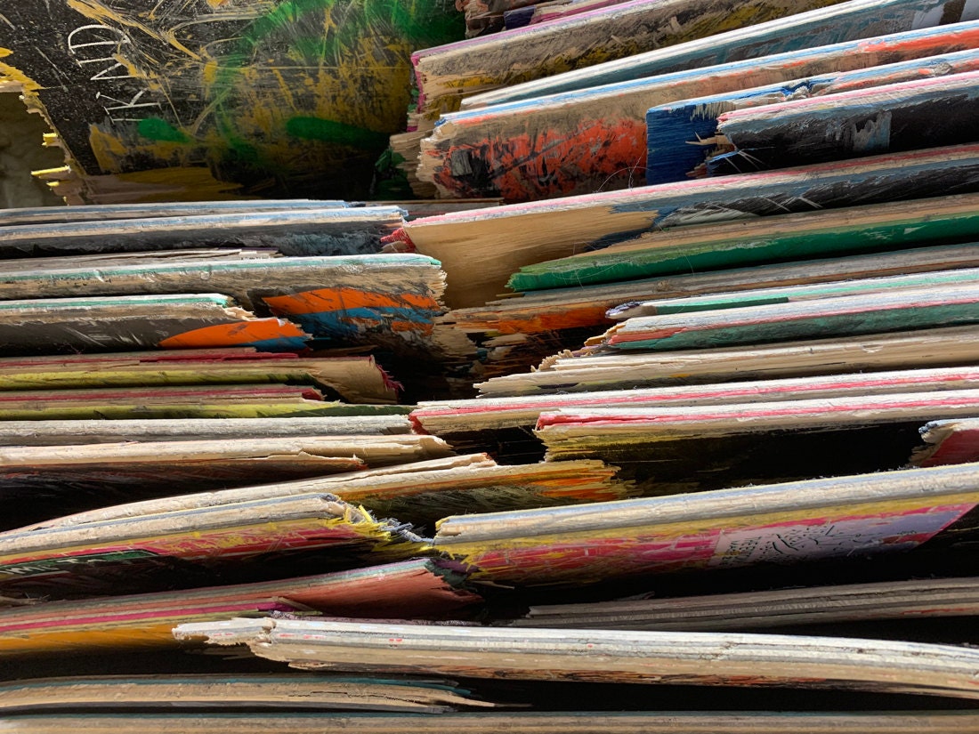 Stacks of broken skateboard decks ready to be repurposed