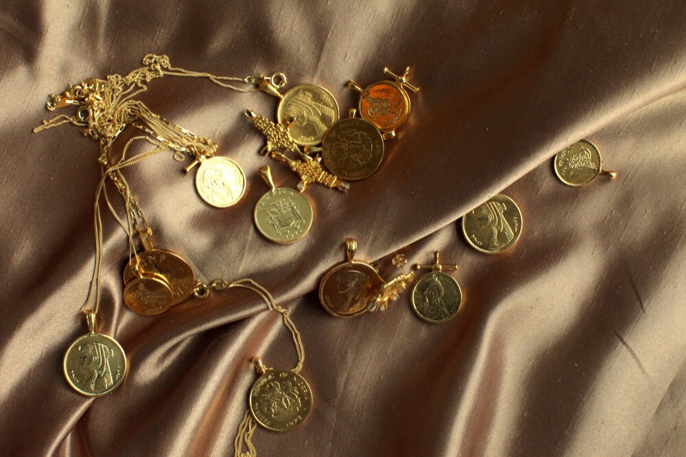 Assorted African gold coin necklaces from Omi Woods