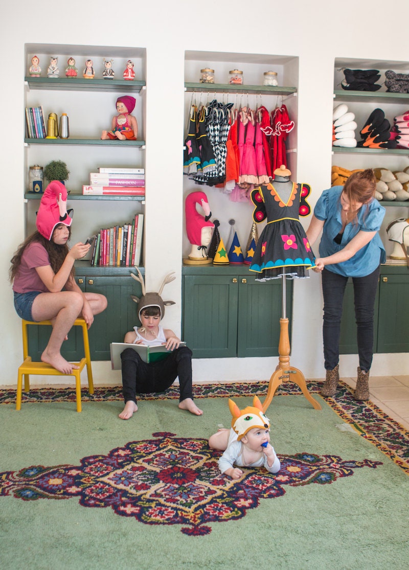 Inbal working in her studio alongside her three children