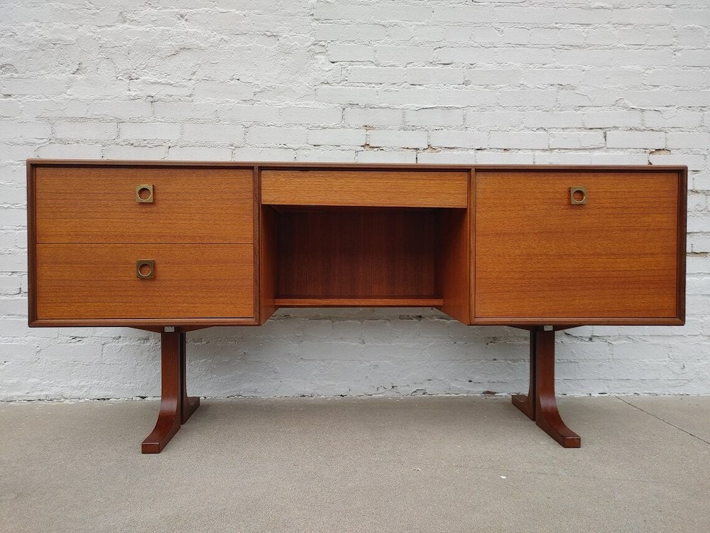 A vintage teak desk from Vintage Vault Tulsa on Etsy.