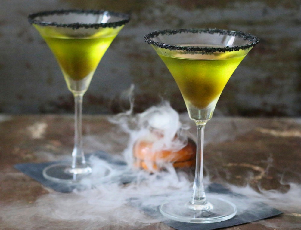 Green poison apple cocktails served in martini glasses