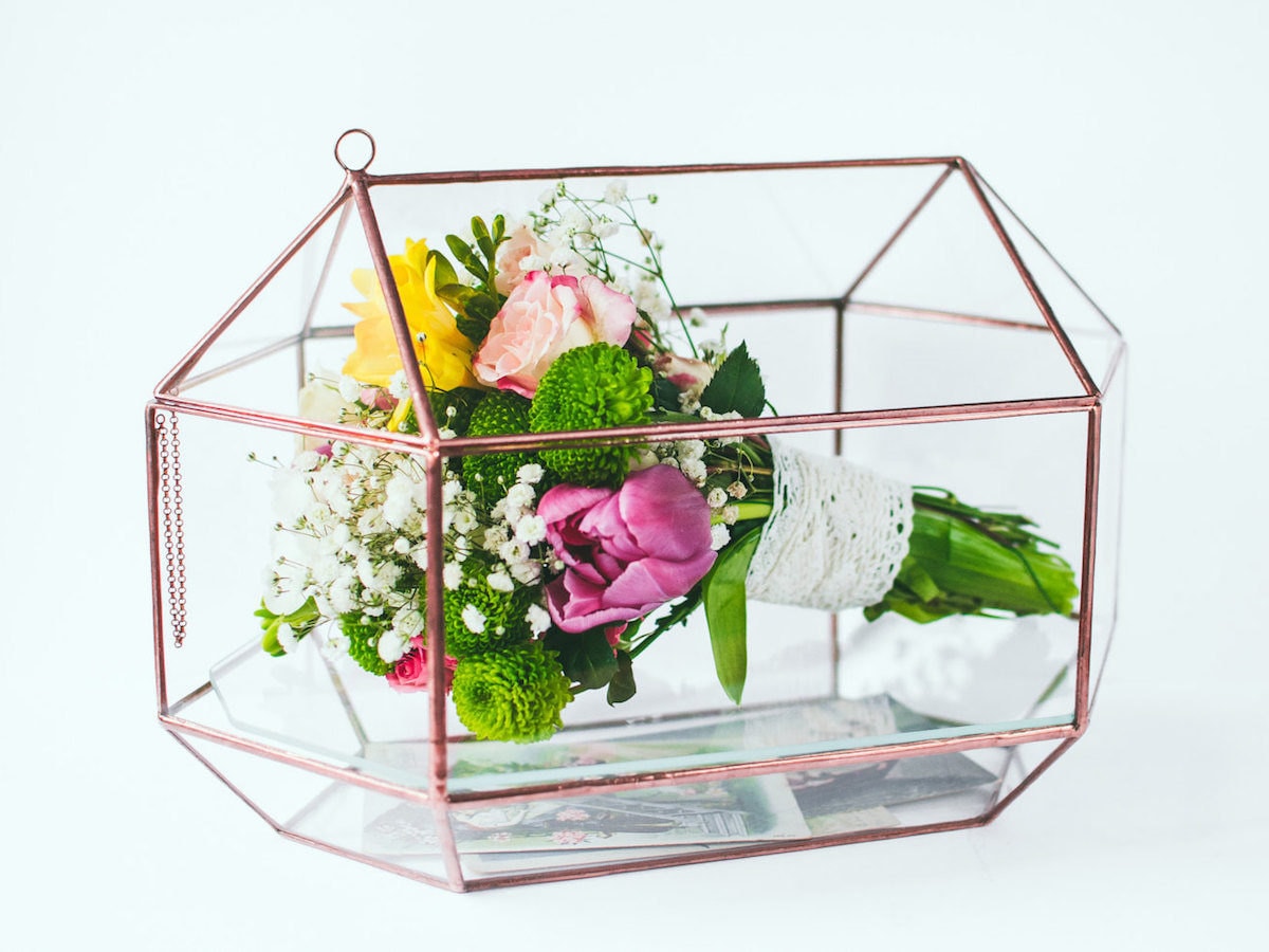 A geometric glass card box and bouquet display case