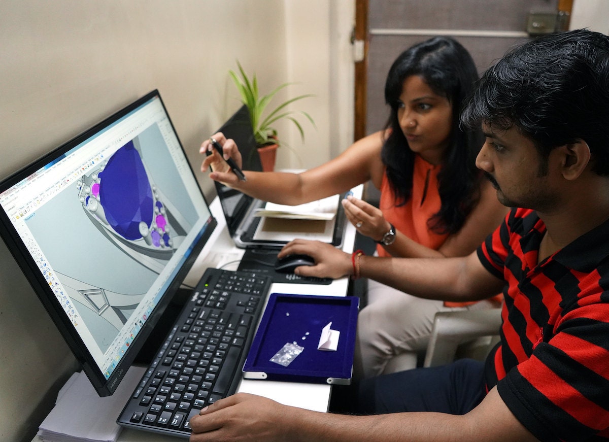 Madhulika and Abhishek discuss a 3D computer model of a new design