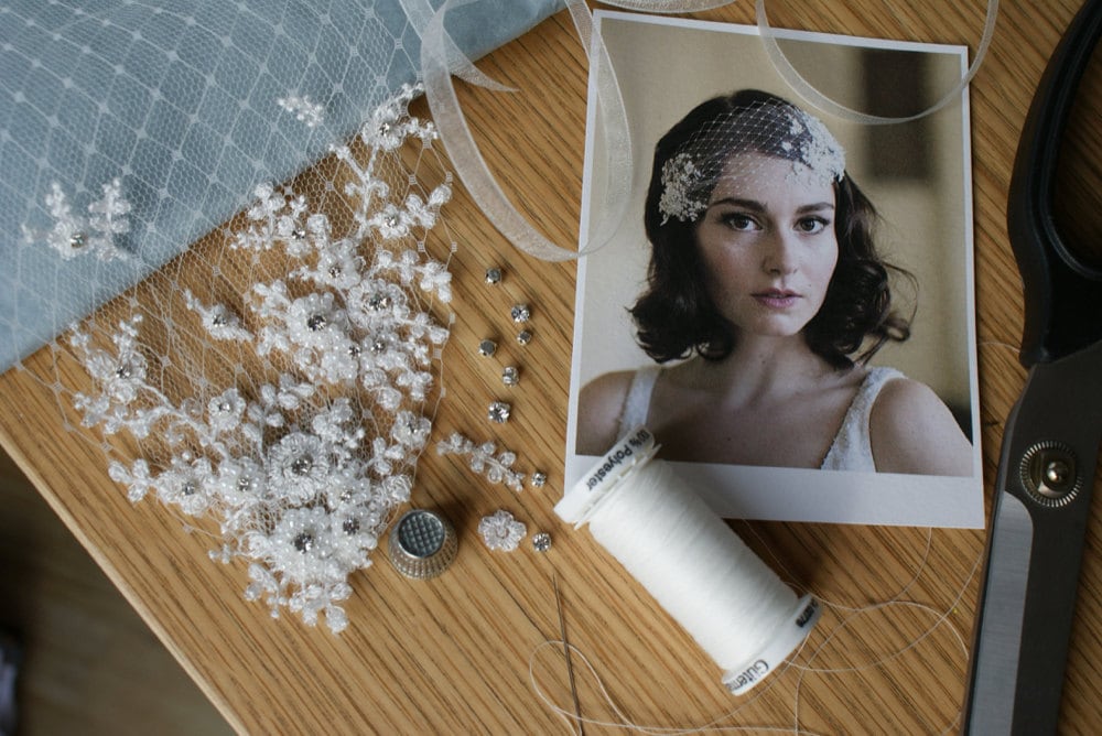 Beads, trimming, and string laid out on a desk before Rae transforms them into a bridal headpiece.