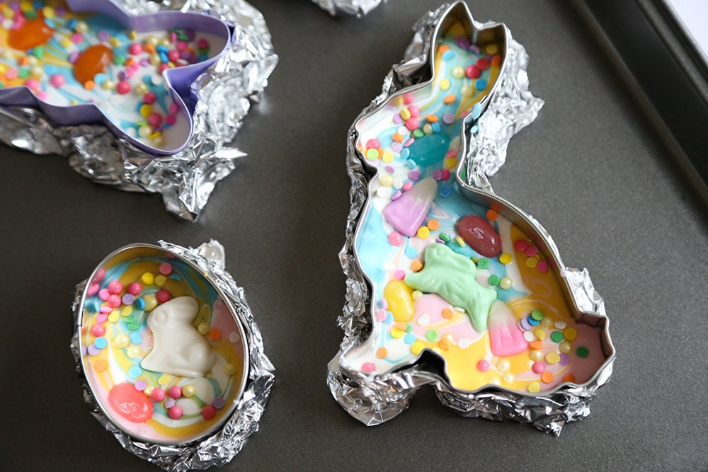 Colorful candies are sprinkled into the melted chocolate