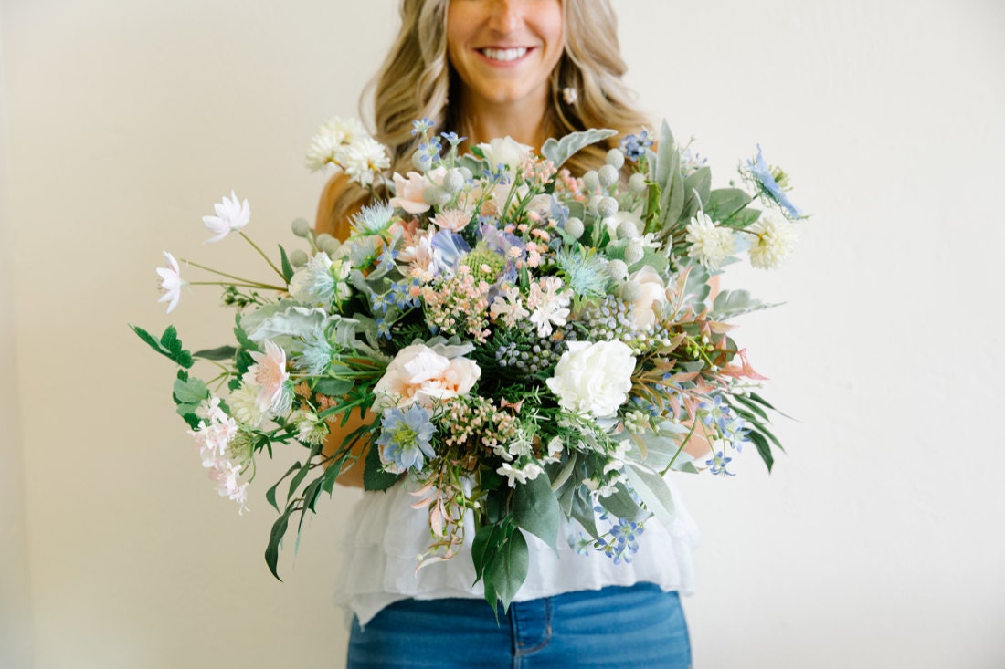 Brittany holds up a finished bouquet
