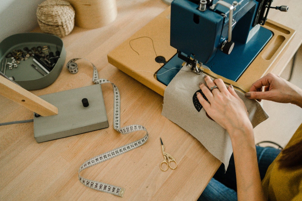 Eda sewing an abstract clutch at her workbench