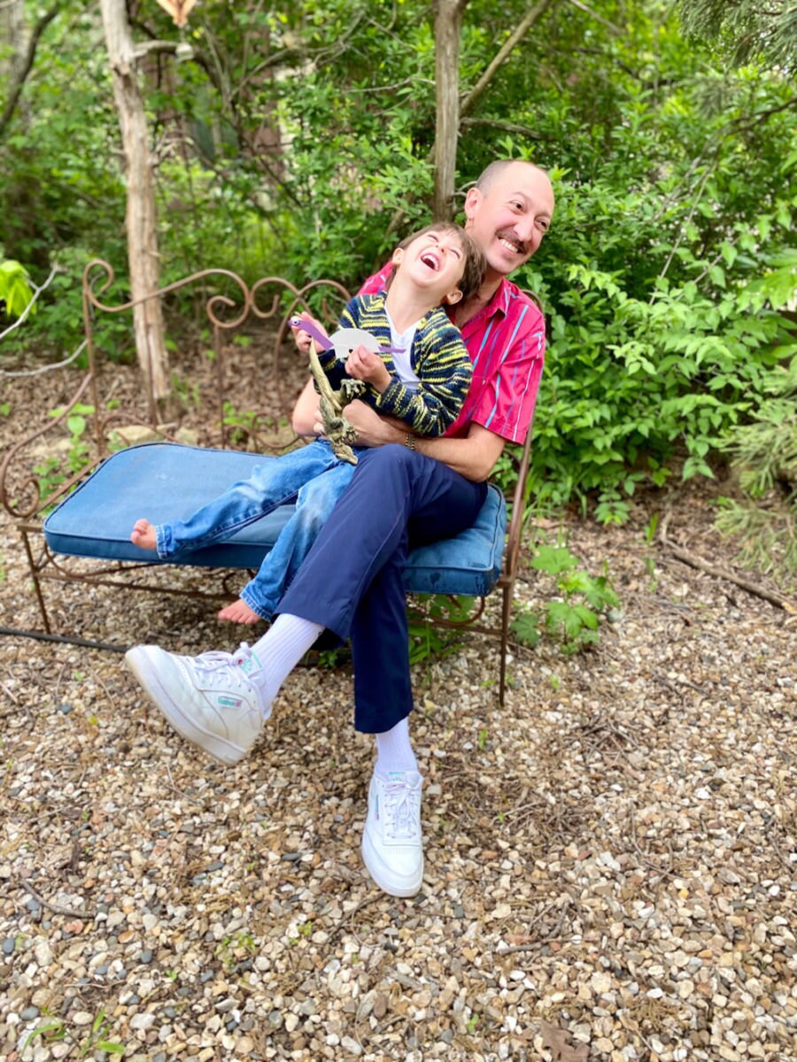 A portrait of Community Specialist Cale Parks and his son.