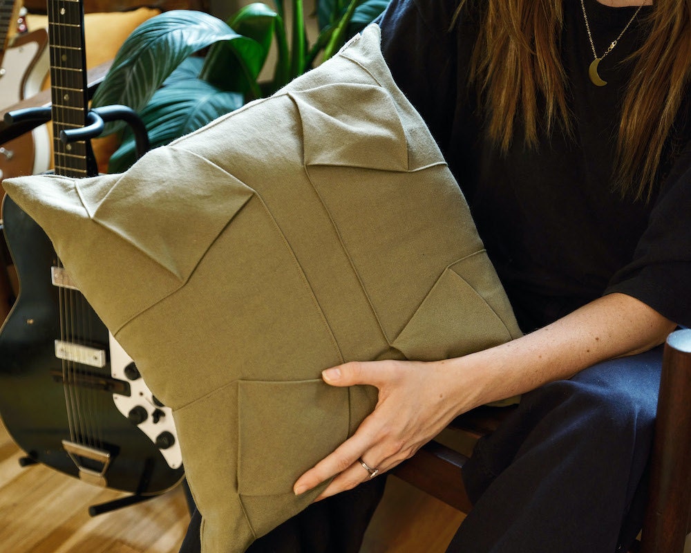 An origami-inspired canvas throw pillow cover from EL ARBOL DE CEREZO on Etsy.
