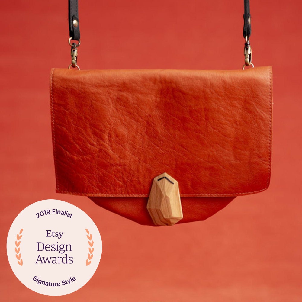 A coral leather purse from VEINAGE