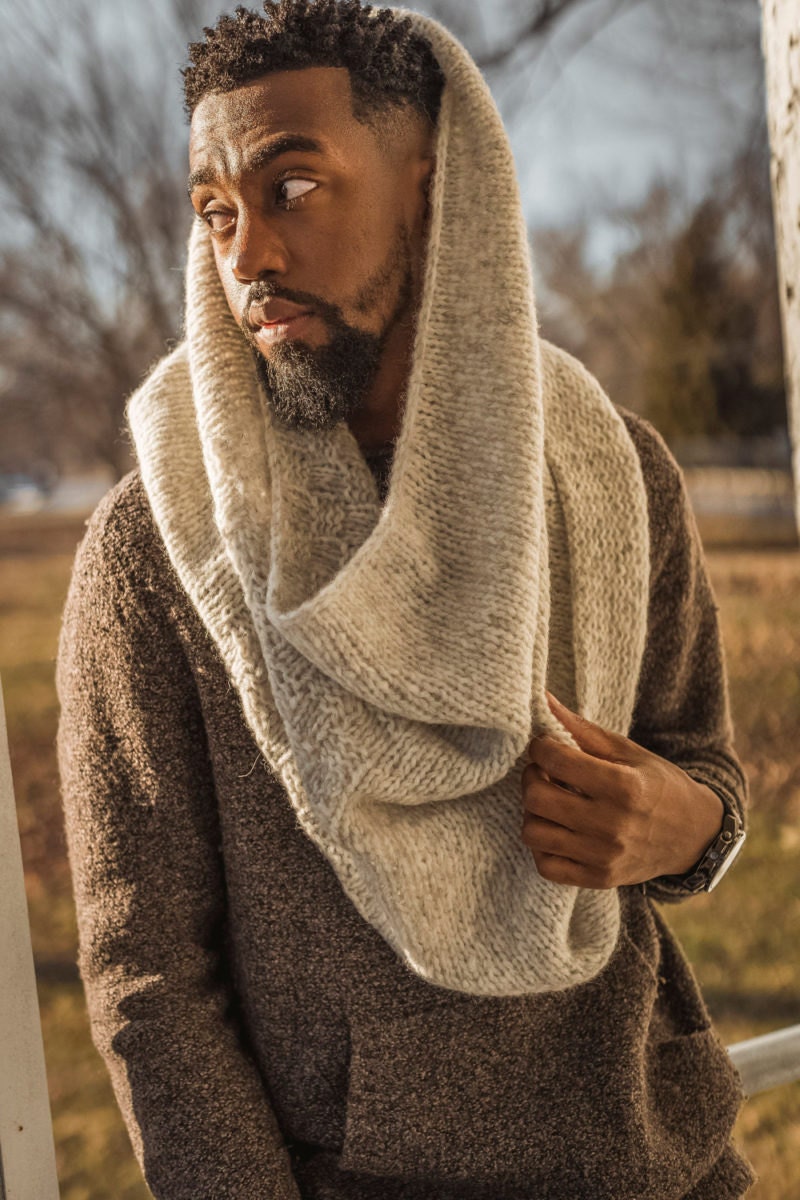 Nathan models a knit cowl—the pattern for which is available for instant download