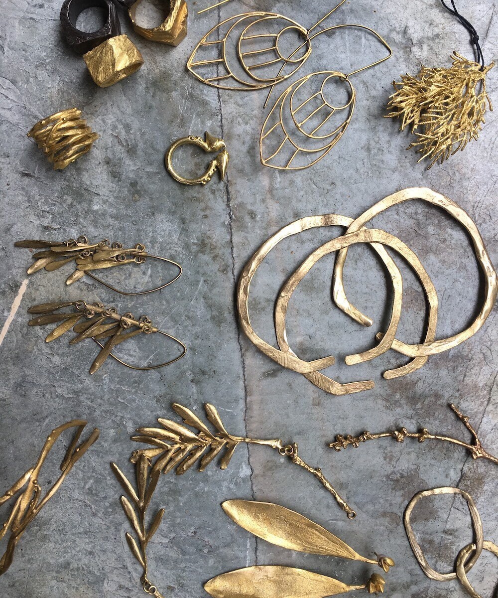 A flat lay of assorted nature-inspired jewelry from Mai Solorzano