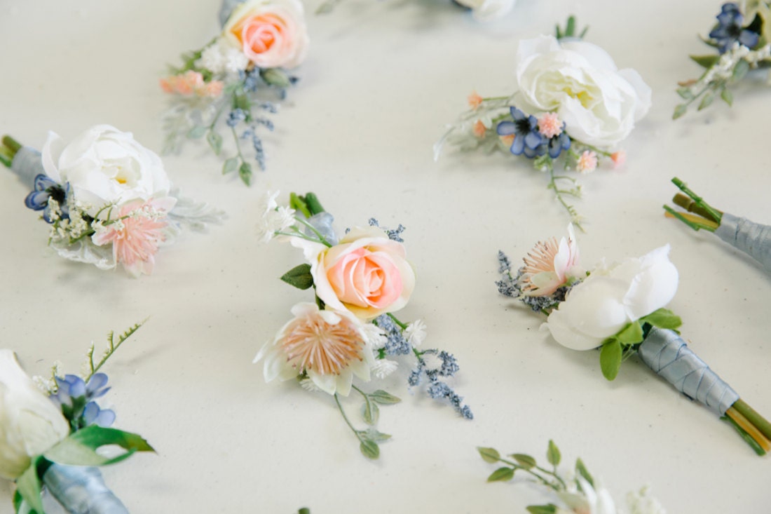 Pink and blue silk boutonnieres from The Faux Bouquets