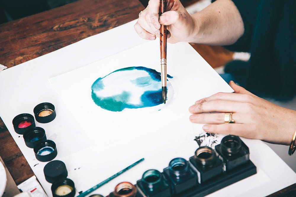 Using watercolor paints at a sip and paint night