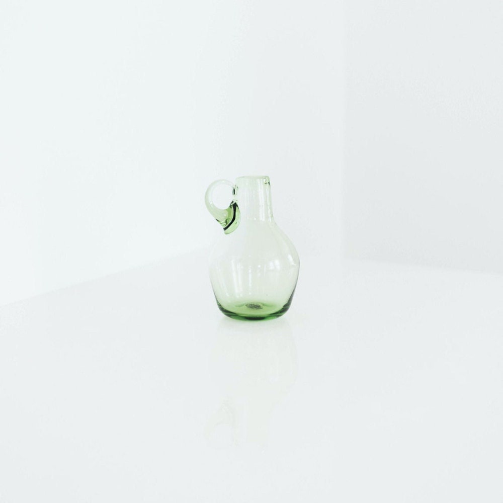 A vintage green blown glass pitcher from Otherwise Shoppe