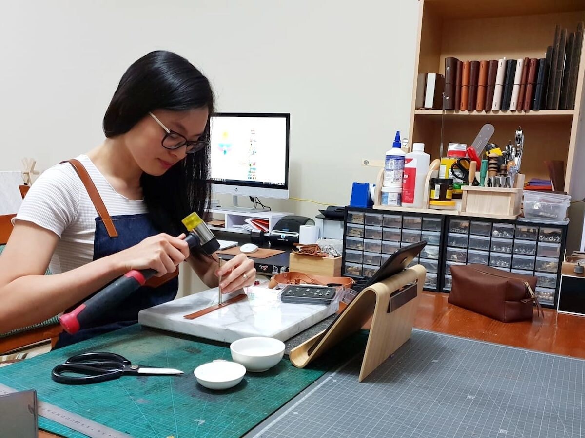 Pauline at work in her studio, personalizing a custom order