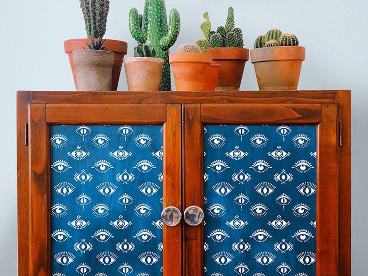 Accent cabinets decorated with eye-patterned stencils.