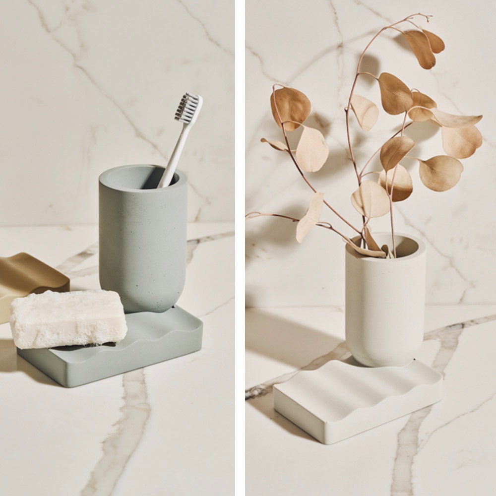 A versatile concrete vessel (displayed as both a vase and toothbrush holder) in multiple colorways, from the Tan France x Etsy collection