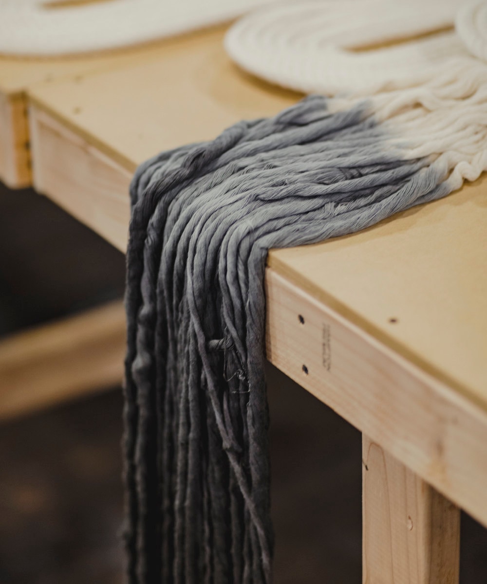 A closeup of blue dip-dyed threads.