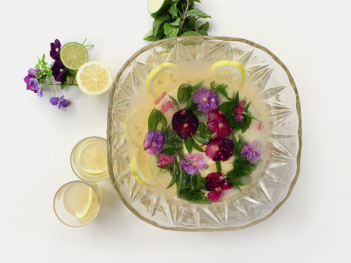 A bowl of summer punch with a decorative block of ice floating in the center.