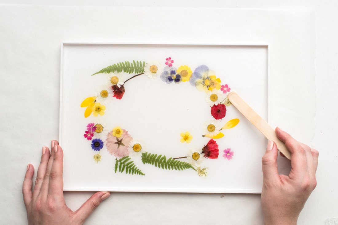 Making small last-minute floral rearrangements with a wood stick