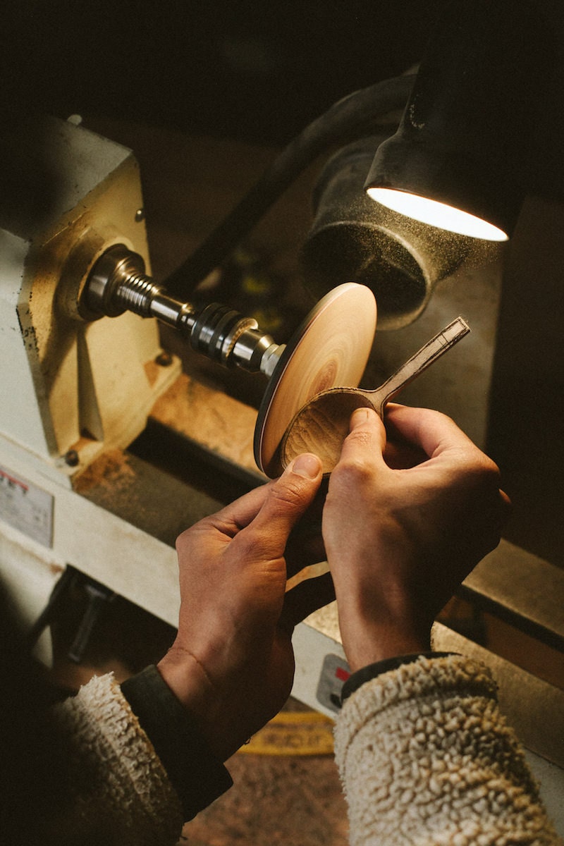 Kirill polishes a spoon-in-progress