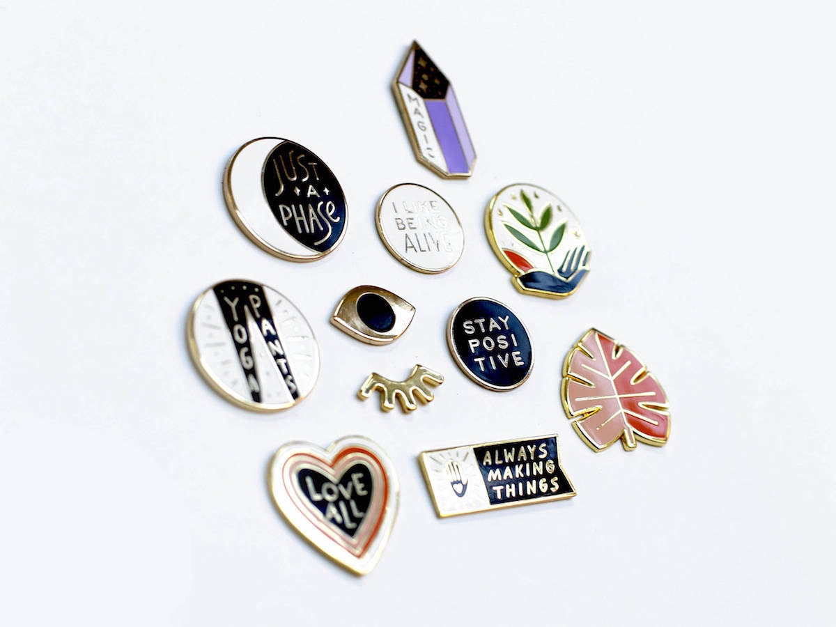 An assortment of motivational enamel pins