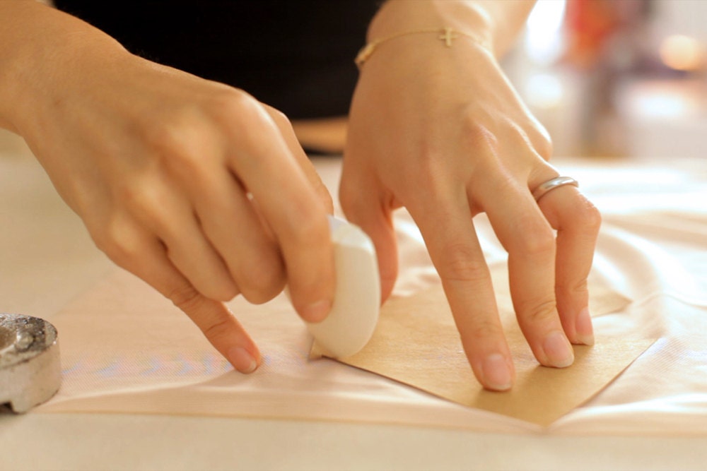 A closeup of Elma making a precise fabric cut