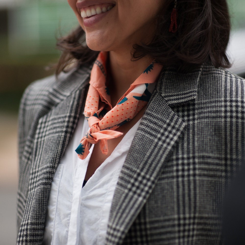 A woman models a bandana worn as a neckerchief from All Very Goods.
