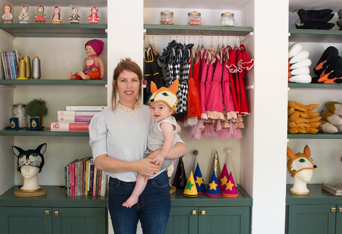 Inbal in her studio, holding her son