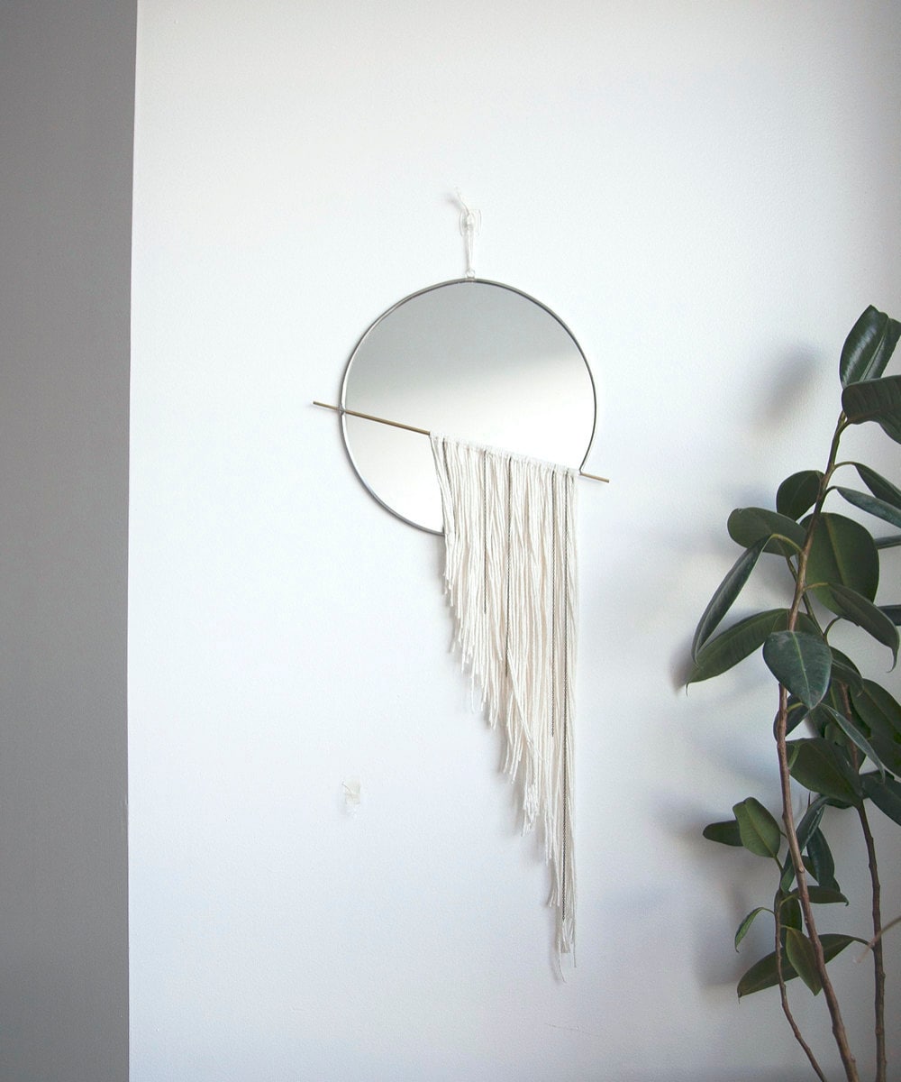 A circle mirror with white fringe from Szklo Glass