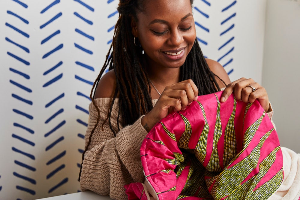 Natalie hand-sews a popular Africa-wax print blanket