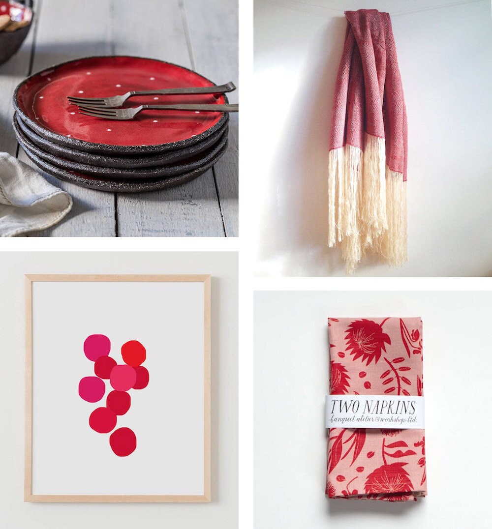 Four ruby-colored items for the home: ceramic dessert plates, a wool throw, a pair of linen napkins, and an abstract art print