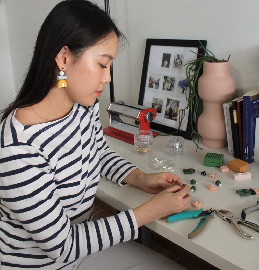 Jessica making jewelry at her desk.