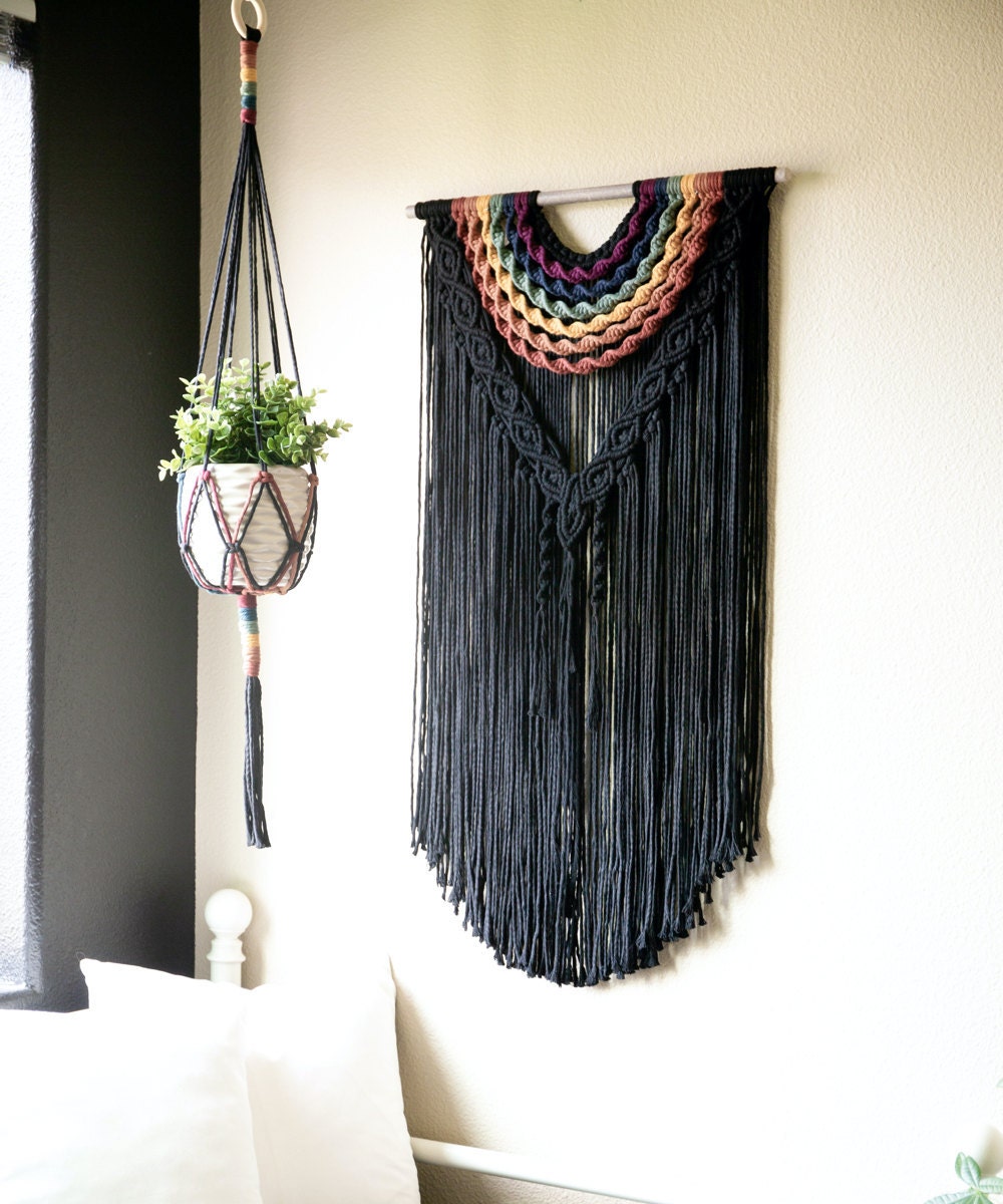 A large, colorful fringed wall hanging from Sweet Home Alberti