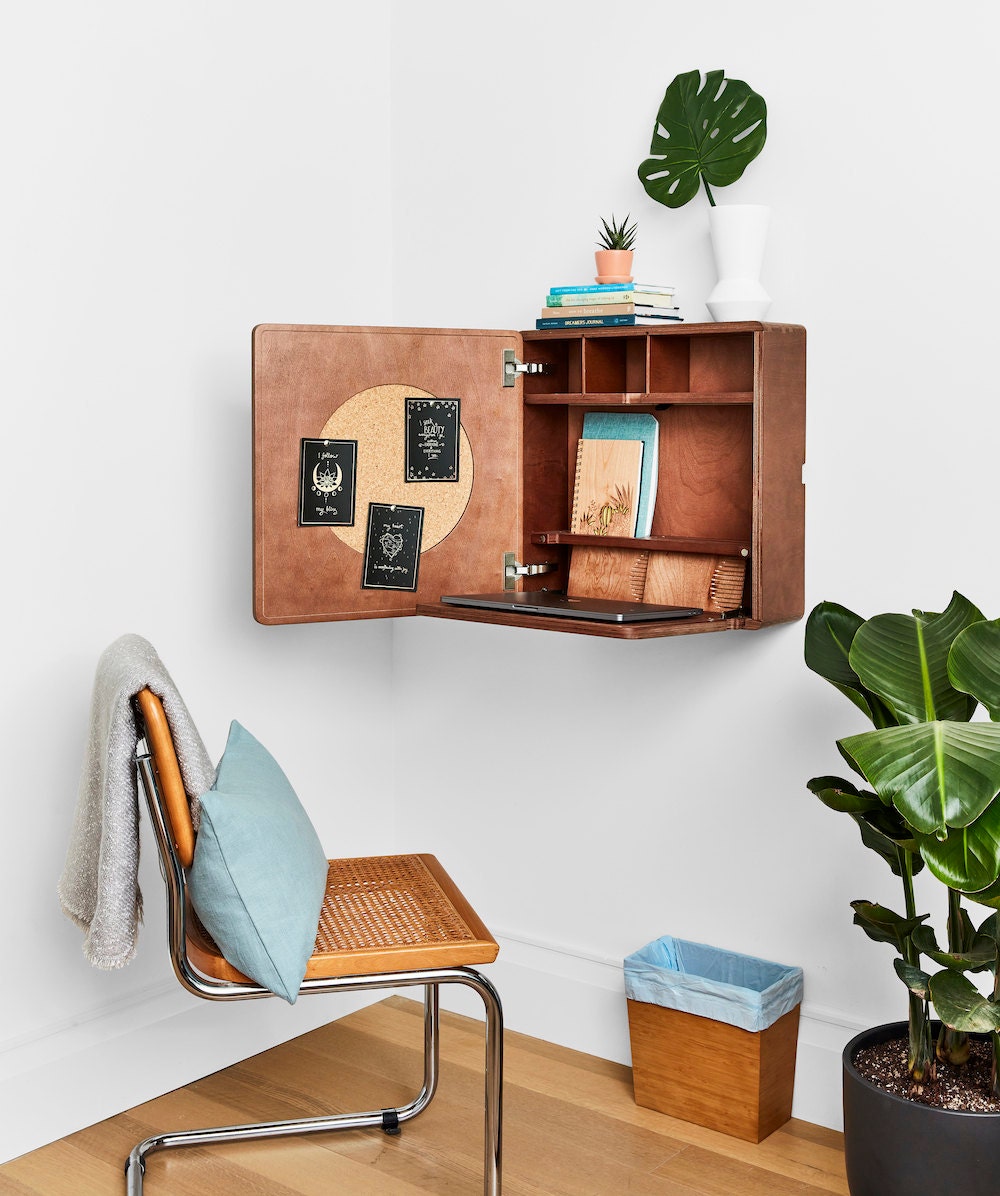 A wide shot of the folding secretary desk and vintage wicker chair that Dayna used to create a compact office space for the Real Simple Home.