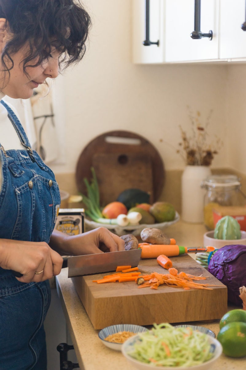 Melanie preps a meal in her Oakland kitchen