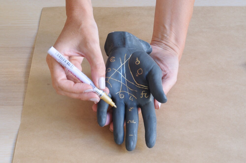 Decorating the painted plaster hand