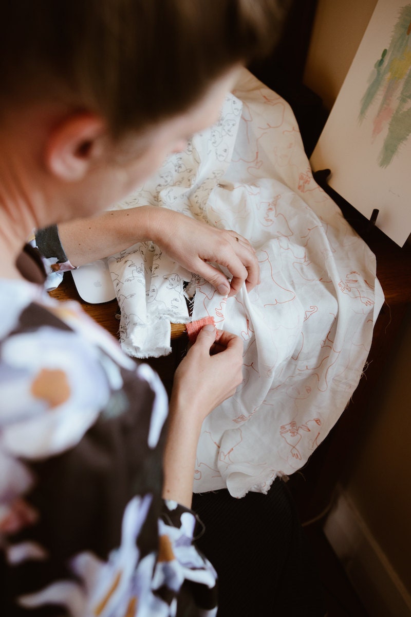 Rabia in her studio, matching colors for a print from her new collection