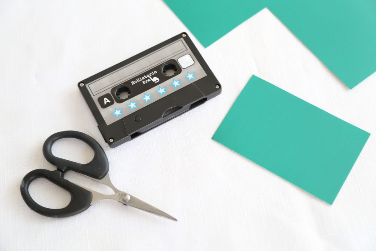An audio cassette used to trace and cut a cookie template out of craft paper.