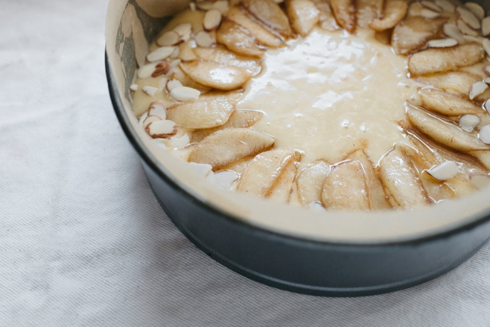 Pouring the batter into the pan and topping with apples