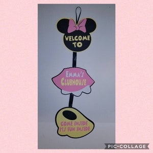 May include: A black and yellow Minnie Mouse head with a pink bow, a pink and yellow skirt with the text "Emma's Clubhouse", and a yellow and black Mickey Mouse ear with the text "Come inside it's fun inside".