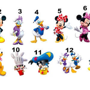 May include: A set of 13 colorful cartoon character iron-on transfers featuring Mickey Mouse, Minnie Mouse, Donald Duck, Daisy Duck, Goofy, Pluto, and other Disney characters. The transfers are numbered 1 through 13.