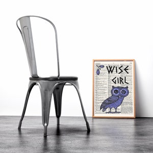 May include: A framed print with a dictionary page background featuring a purple owl with the text "WISE GIRL" in black lettering.