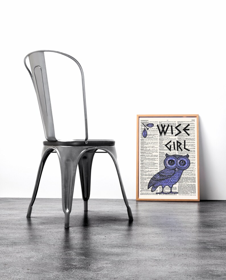May include: A framed print with a dictionary page background featuring a purple owl with the text "WISE GIRL" in black lettering.
