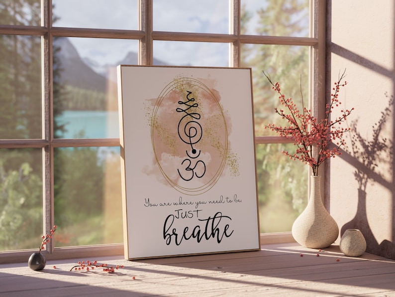 May include: A beige and gold watercolor print with a black Om symbol and the text "You are where you need to be JUST breathe".