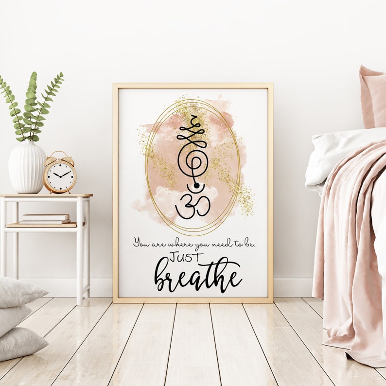 May include: A gold and pink watercolor print with a black and gold Om symbol and the text "You are where you need to be JUST breathe".