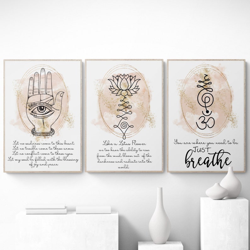 May include: Three printable wall art prints with a pink watercolor background and gold glitter accents. The first print features a hand with an eye in the palm, the second print features a lotus flower, and the third print features the Om symbol with the text "You are where you need to be, Just breathe".