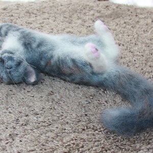 Needle felted wool sculpture of a very relaxed sleeping gray tabby cat